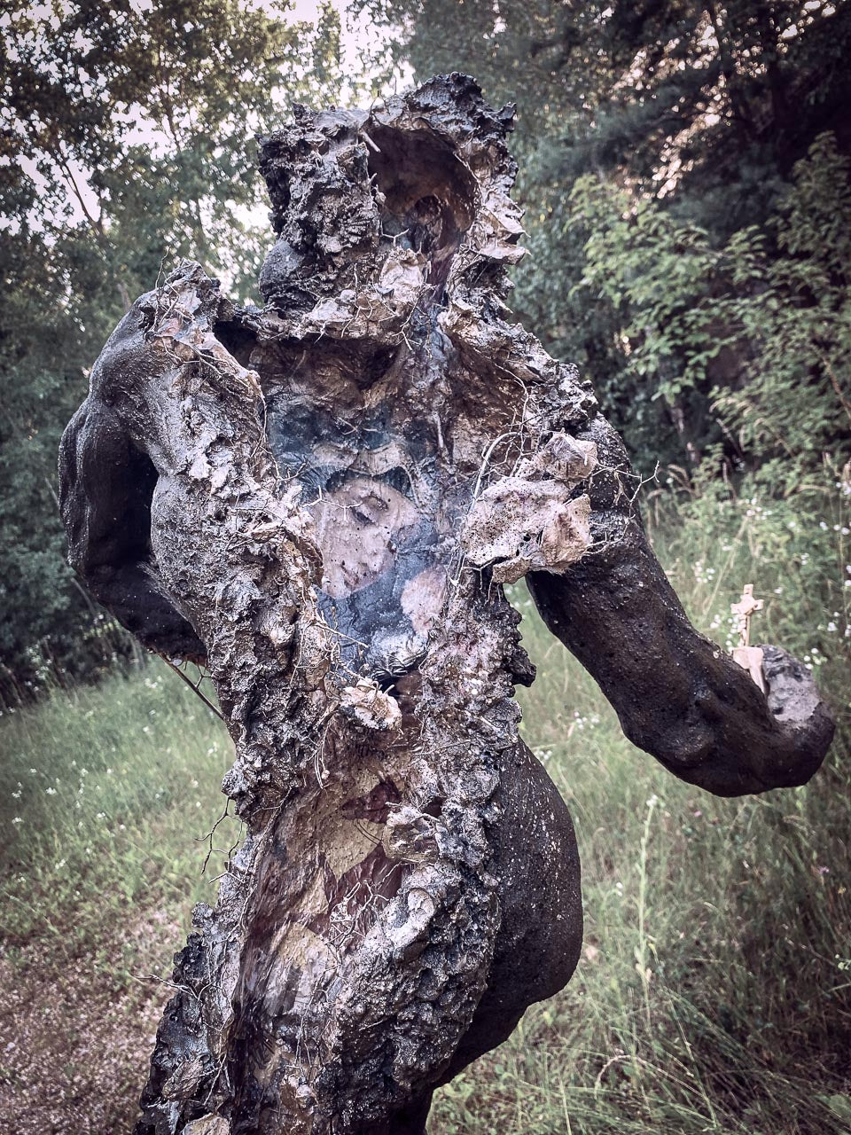 detailansicht von aufgerissenem rücken der hohlen skulptur, tapeziert mit heiligen bildern, fresken, ikonen von maria und anderen heiligen, goldig glänzend, morbide ,zerstörte Darstellung wie eine zerbombte sakralbau ruine